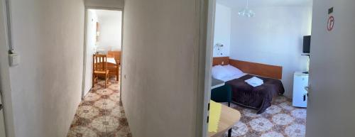 a room with a bedroom with a bed and a table at Willa Rodzinna in Mielno