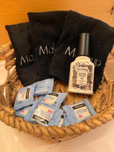 a basket with a bottle of soap and other products at Cozy Cabin Getaway! in Fancy Gap