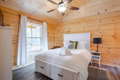a bedroom with a bed in a wooden cabin at Cozy Cabin Getaway! in Fancy Gap