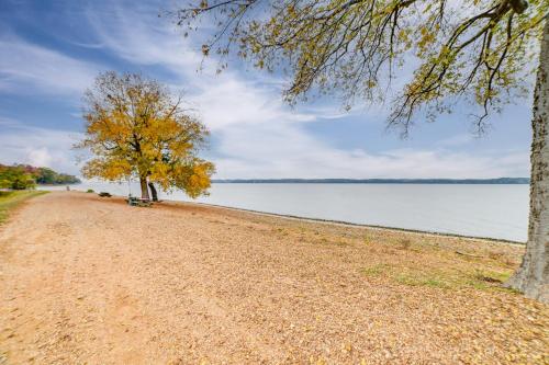 a dirt road next to a body of water at Walk to Lake Dover Cabin with Views and Porch in Durham Subdivision