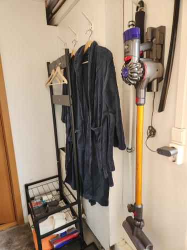 a coat hanging on a wall next to a fan at LAVA Studio Keflavik in Keflavík