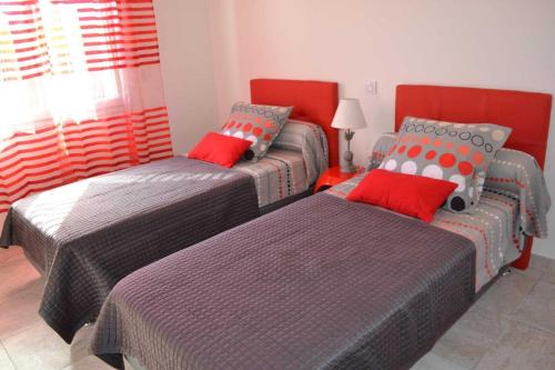 a bedroom with two twin beds and a window at Collioure in Latour-Bas-Elne