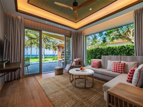 a living room with a couch and a table at Radisson Blu Resort Cam Ranh in Cam Ranh