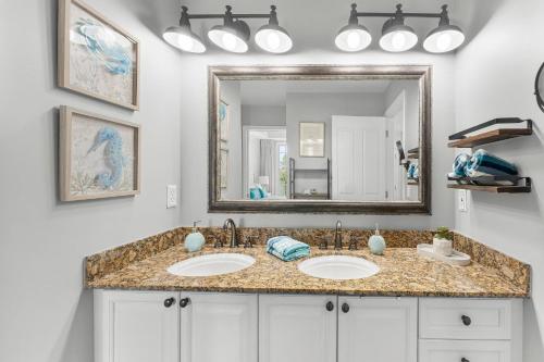 a bathroom with two sinks and a large mirror at Reflections 307 in Panama City Beach