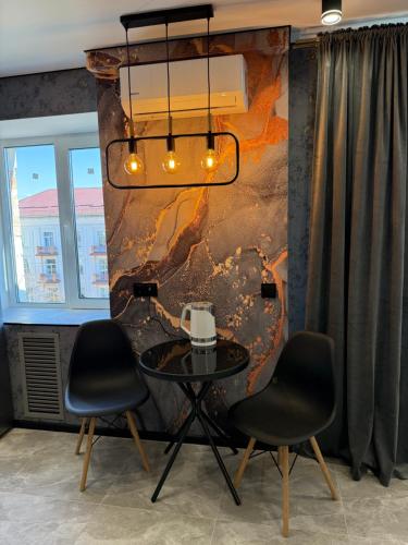 a dining room with a table and two chairs at Люкс апартаменти в самому центрі in Chernihiv
