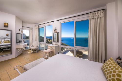 a bedroom with a bed and a view of the ocean at Villa Dolluca in Kaş
