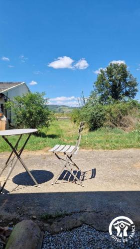 a picnic table and a bench sitting on the side of a road at Le chinchilla in Gaillac