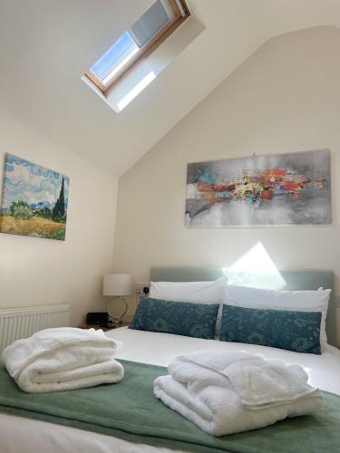 a bedroom with a bed with towels on it at The Parson Woodforde in Norwich