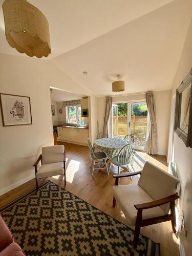 a living room with a table and chairs at Southend Long Barn in Ogbourne Saint George