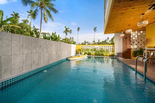 a swimming pool in a house with a resort at Naraco Homestay Hoi An in Cam Thanh