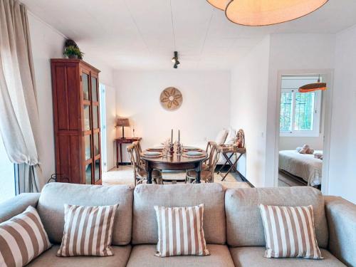 a living room with a couch and a table at Villa Marie, 8 pers, green zone, private in GRO