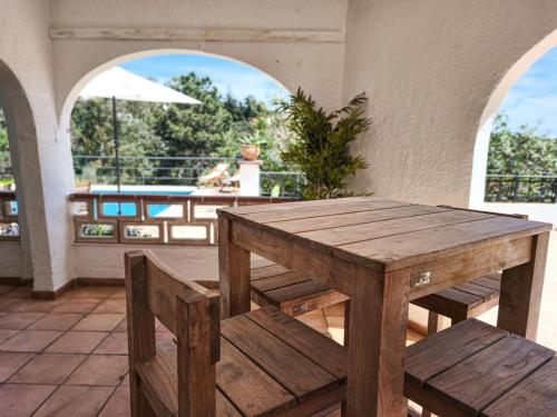a wooden table and benches on a patio at Villa Marie, 8 pers, green zone, private in GRO
