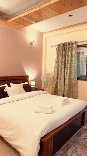 a bedroom with two beds and a window at Leo casa stairs to heaven in Mussoorie