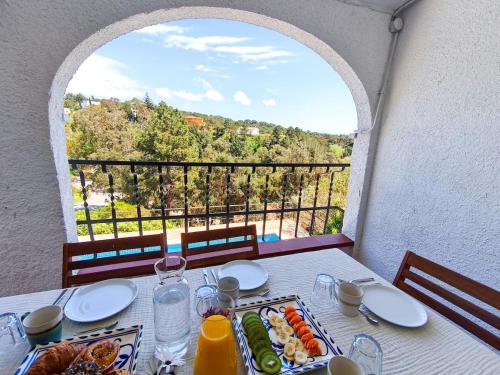 a table with a plate of food and a view at Villa Marie, 8 pers, green zone, private in GRO