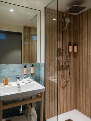 a bathroom with a sink and a shower at La Belle Ville in Paris