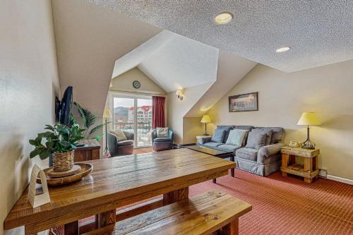 a living room with a table and a couch at Mountainview Condo at Rivergreen in Lincoln