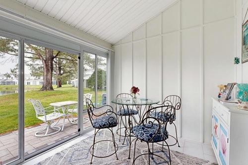a patio with a table and chairs on a porch at Mallard Lakes - 142 Cardinal in Selbyville