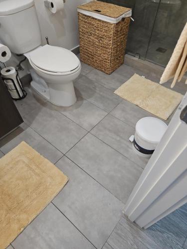 a bathroom with a toilet and a shower with mats at Miami-Brickell Luxury 2BR-2BATH with skyline VIEWS - walking distance to HEAT ARENA & BAYSIDE in Miami