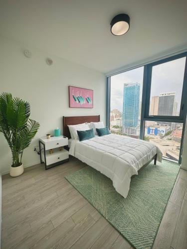 a bedroom with a large bed and a large window at Miami-Brickell Luxury 2BR-2BATH with skyline VIEWS - walking distance to HEAT ARENA & BAYSIDE in Miami