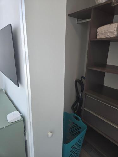 a walk in closet with a blue basket in it at Miami-Brickell Luxury 2BR-2BATH with skyline VIEWS - walking distance to HEAT ARENA & BAYSIDE in Miami