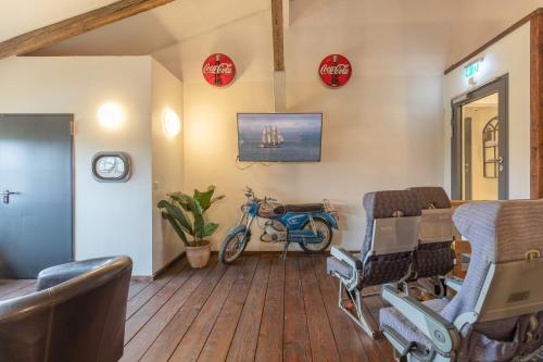 a room with a bed and a motorcycle in it at Lodge an der Eider in Friedrichsgraben