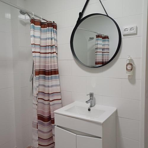 a bathroom with a sink and a mirror at Inn Golegã in Golegã