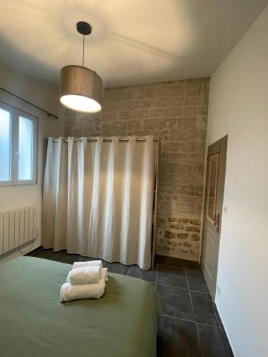 a bedroom with a bed and a white curtain at Appartement dans centre historique in Tarascon