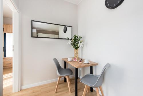 a dining room with a table and chairs at Central Apartments by Bed&Bath in Kraków