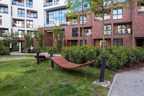 a park bench in front of a building at Central Apartments by Bed&Bath in Kraków