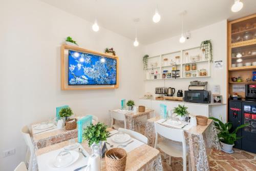 a restaurant with three tables and a counter with a kitchen at Ciccio Rooms and breakfast - Self check-in in Palermo