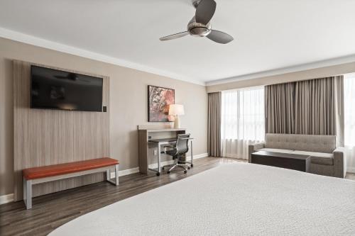 a hotel room with a bed and a desk at Holiday Inn Baton Rouge College Drive I-10 by IHG in Baton Rouge
