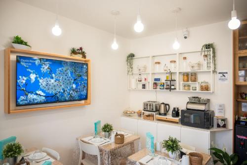 a room with two tables and a tv on the wall at Ciccio Rooms and breakfast - Self check-in in Palermo