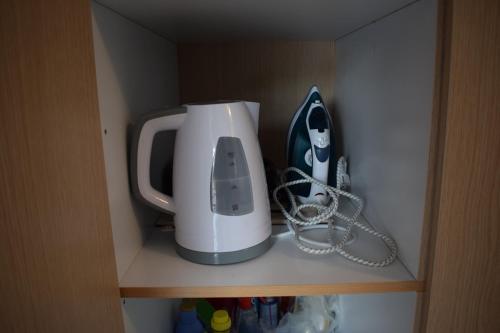 a toaster sitting on a shelf in a cabinet at Traditional apartment in nature in Kouvaláta