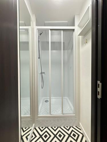 a shower with a glass door in a bathroom at Emun Grigo Lofthouse in Cluj-Napoca