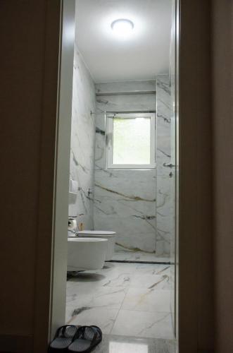 a bathroom with a tub and a sink at Hotel ERALD in Begjunec