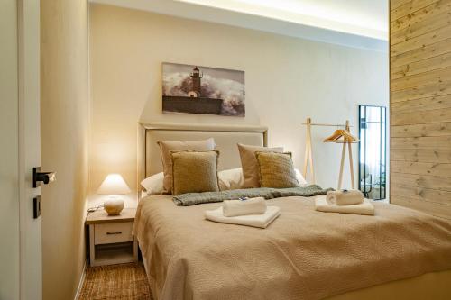 a bedroom with a large bed with two towels on it at STING Boutique Apartments in Ostrava
