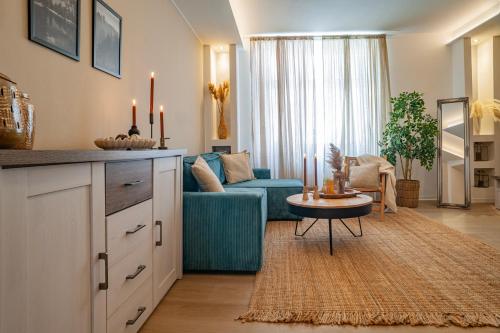 a living room with a blue couch and a table at STING Boutique Apartments in Ostrava