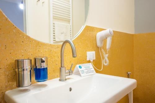 a bathroom with a sink and a mirror at Ciccio Rooms and breakfast - Self check-in in Palermo