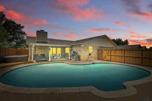 a large swimming pool in front of a house at Modern & Chic 4BD,2BA - Pool, Hot Tub, BBQ Grill in Carrollton