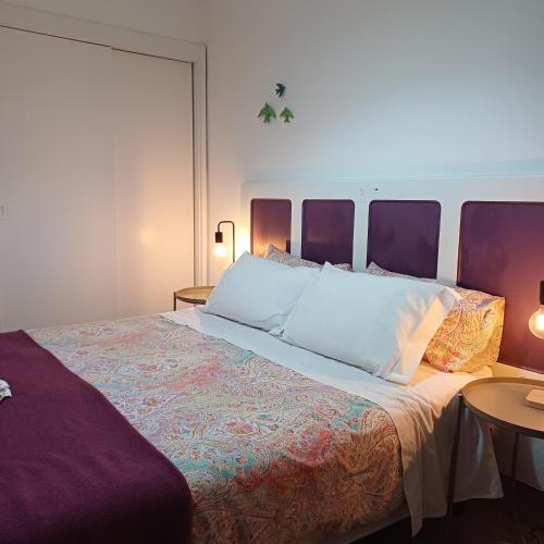a bedroom with a large bed and two tables at Inn Golegã in Golegã