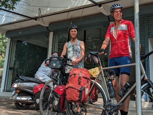 a man and a woman standing next to a bike at Little home apartment in Kozhikode