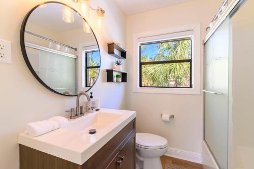 a bathroom with a sink and a mirror at Clearwater Hideaway w Huge Lap POOL 7 min to BEACH in Clearwater