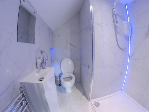 a white bathroom with a shower and a toilet at Twenty Hotel and Bar in Boston