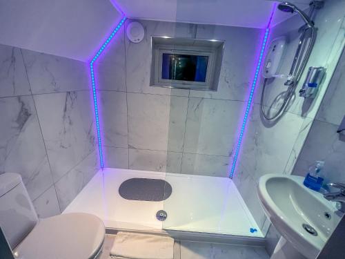 a bathroom with a toilet and a sink and a tv at Twenty Hotel and Bar in Boston