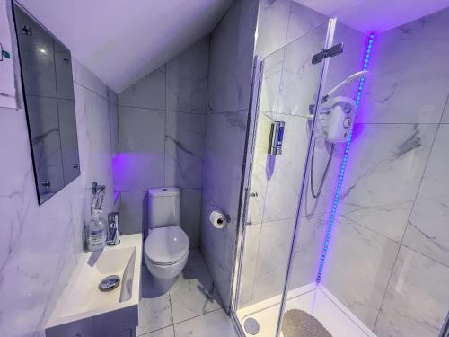 a bathroom with a shower and a toilet and a sink at Twenty Hotel and Bar in Boston