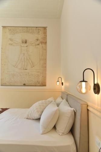 a bedroom with a bed with two pillows at Pension 2Be in Nafplio
