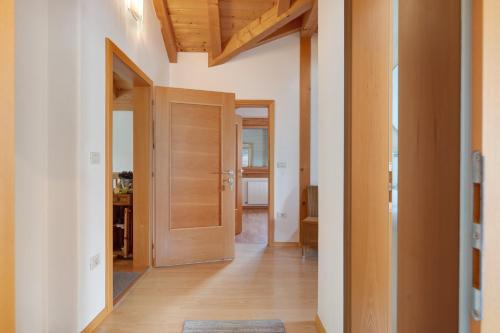 an open hallway with wooden doors in a home at Hofanger in Lagundo
