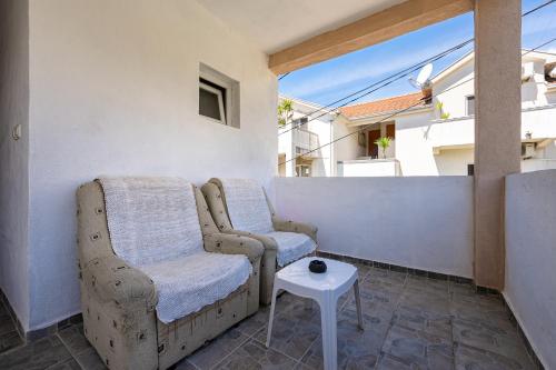 a room with two chairs and a table on a balcony at Avdic Apartments in Tivat