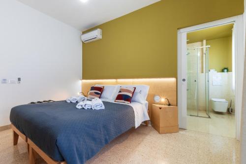 a bedroom with a large bed and a shower at Ciccio Rooms and breakfast - Self check-in in Palermo