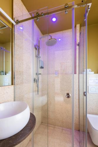 a bathroom with a glass shower and a sink at Ciccio Rooms and breakfast - Self check-in in Palermo